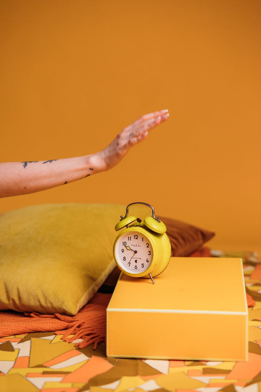 yellow alarm clock on a yellow box